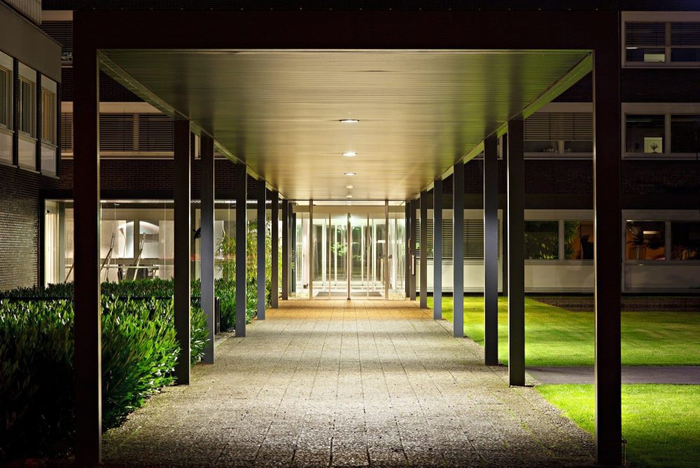 A lit external walkway between two office buildings.